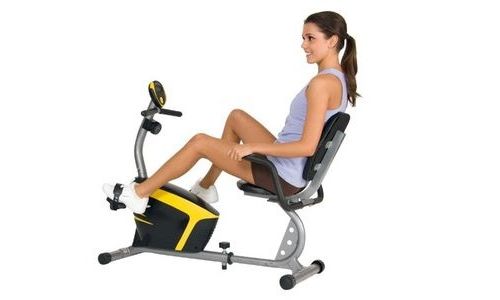 A young woman using the best recumbent exercise bike 